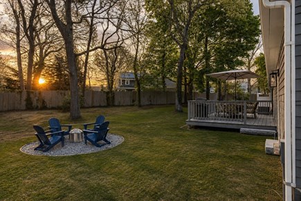 Brewster Cape Cod vacation rental - Private yard with fire pit & Adirondack chairs