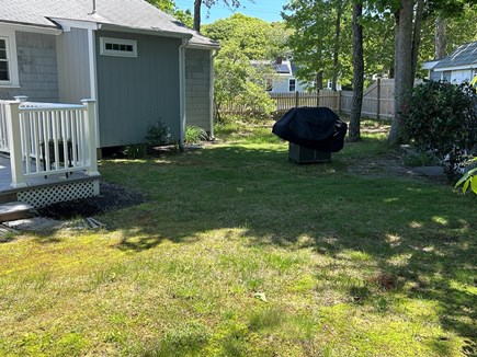 West Dennis Cape Cod vacation rental - Backyard and side yard with grill