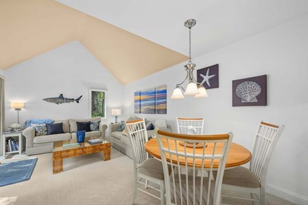 New Seabury, Mashpee Cape Cod vacation rental - Open living room and dining area, featuring a seamless layout that creates a spacious and inviting setting for relaxing, dining, and gathering with fa