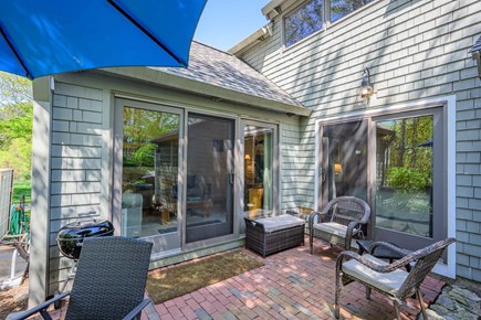 New Seabury, Mashpee Cape Cod vacation rental - Patio with seating, offering a comfortable outdoor space to relax, unwind, and enjoy the surrounding natural setting.