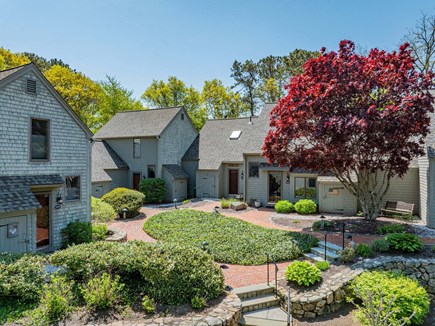 New Seabury, Mashpee Cape Cod vacation rental - Front patio surrounded by beautiful landscaping, offering a welcoming outdoor space with thoughtfully maintained greenery and charming curb appeal.