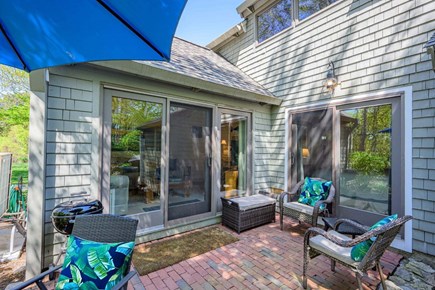 New Seabury, Mashpee Cape Cod vacation rental - Patio with seating, offering a comfortable outdoor space to relax, unwind, and enjoy the surrounding natural setting.