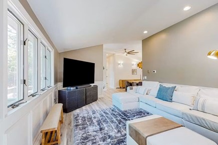 Bourne Cape Cod vacation rental - Bright living room with sectional, 83-inch smart TV, and seating