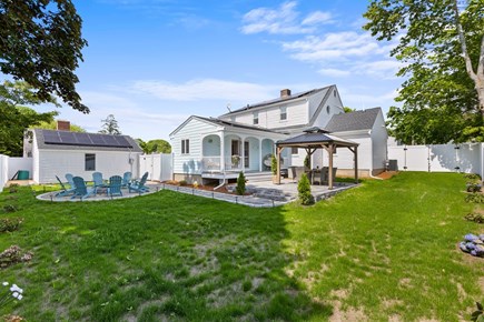 Hyannis Cape Cod vacation rental - Fully fenced backyard with grill, fire pit, w plenty of seating