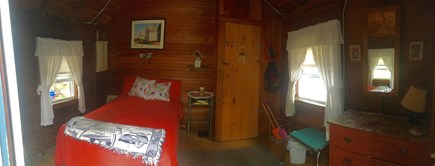 Outer Cape / Wellfleet Cape Cod vacation rental - Cozy wood-paneled bedroom with rustic charm.