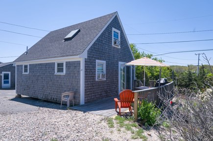 East Sandwich Cape Cod vacation rental - Front of the home with a deck, seating and grill.