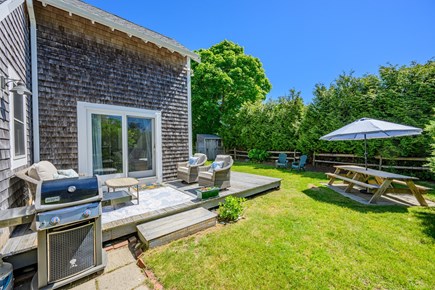 Chatham Cape Cod vacation rental - View of the full backyard featuring the deck and outdoor seating area