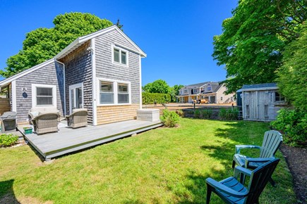 Chatham Cape Cod vacation rental - View of the full backyard featuring the deck and outdoor seating area,