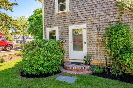 Chatham Cape Cod vacation rental - Front door with greenery, creating a warm and welcoming entryway with natural accents.