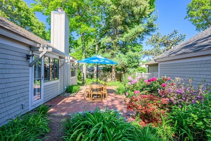 Mashpee Cape Cod vacation rental - The back patio  opens into a peaceful garden oasis