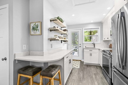 Brewster Cape Cod vacation rental - The kitchen offers countertop seating, providing a casual and convenient spot for meals, morning coffee, or gathering while meals are being prepared.