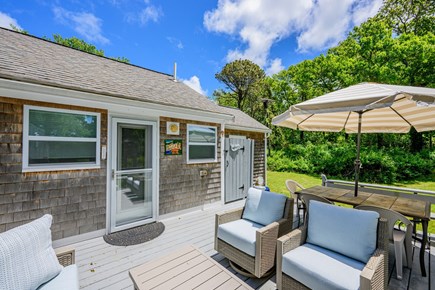 Brewster Cape Cod vacation rental - Deck featuring seating, a dining table, and an outdoor shower, offering a versatile outdoor space