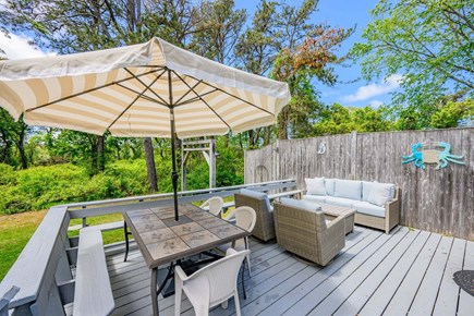 Brewster Cape Cod vacation rental - Deck with table, chairs, and seating area, offering a comfortable outdoor space
