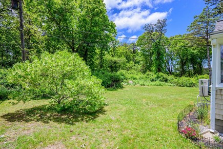 Brewster Cape Cod vacation rental - Backyard offering an outdoor space for relaxation, surrounded by the natural setting of the property.