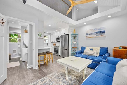 Brewster Cape Cod vacation rental - Living room flowing into the kitchen, featuring an open and connected layout that creates a spacious atmosphere for relaxing, cooking, and gathering t