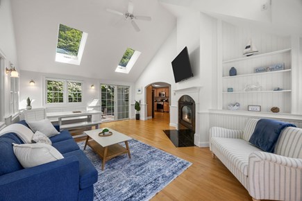 Dennis Cape Cod vacation rental - Living room with TV and corner dining table