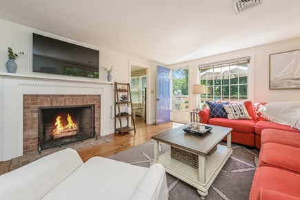 Chatham Cape Cod vacation rental - Living room with fire place, flat screen TV and ample seating to unwind! Deck entrance and bedroom #1 are off the living area- 80 Lienau Dr Chatham Ma