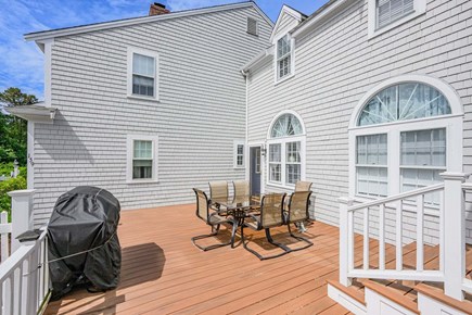 Centerville Cape Cod vacation rental - Outdoor deck featuring a dining area and grill, perfect for al fresco meals, entertaining, and enjoying the fresh air.