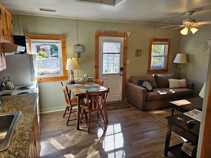 Dennisport Cape Cod vacation rental - Overview of kitchen, dining area and couch