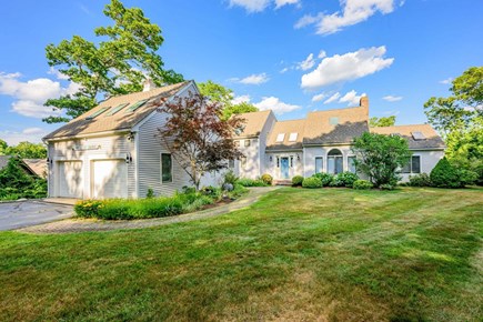 Plymouth MA vacation rental - Exterior front yard view featuring the home’s welcoming entrance and manicured grounds