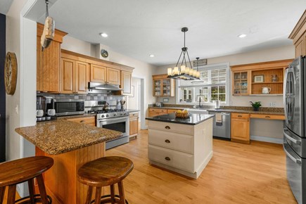Yarmouth Port Cape Cod vacation rental - Kitchen with views overlooking backyard pool and poolhouse
