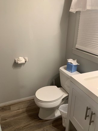 West Yarmouth Cape Cod vacation rental - 1st floor small bathroom with stand up shower across from toilet.