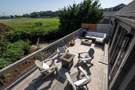 Hyannis Cape Cod vacation rental - Deck with Adirondack chairs, gas firepit, grill and couch seating