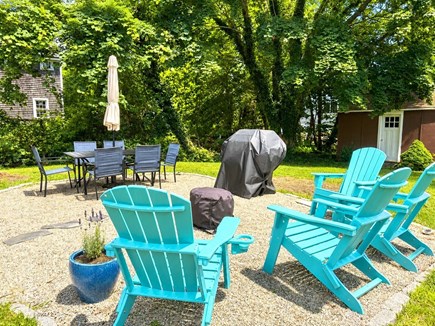 Falmouth Cape Cod vacation rental - Backyard with fire pit, Adirondack chairs, Weber grill and table