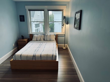 Wellfleet Village Cape Cod vacation rental - Guest bedroom with double bed, reading lamp, and natural light