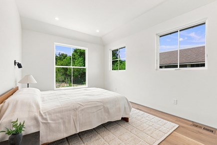 Orleans, Nauset Tide Cape Cod vacation rental - Queen bedroom with natural oak floors and bright windows