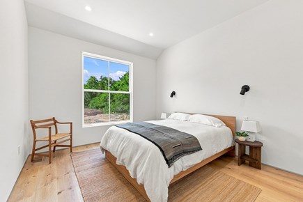 Orleans, Nauset Tide Cape Cod vacation rental - Queen bedroom with vaulted ceiling, white bedding and navy rugs