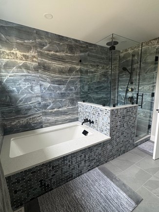 N Falmouth Cape Cod vacation rental - Primary bathroom with a soak-in tub and walk-in shower