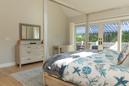 N Falmouth Cape Cod vacation rental - Primary bedroom with attached bath and patio access