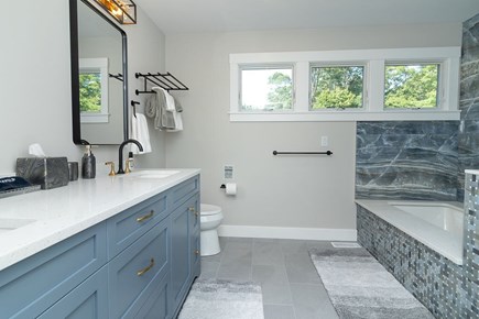 N Falmouth Cape Cod vacation rental - Primary attached bathroom with soaking tub & shower on main floor