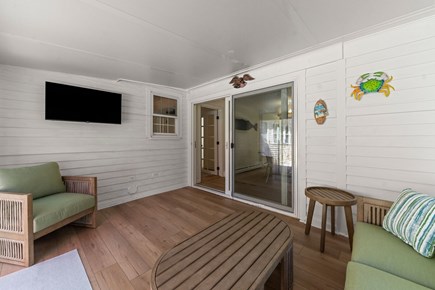West Yarmouth Cape Cod vacation rental - Porch with sofa, Roku Smart TV, Tiki Toss - opens to patio