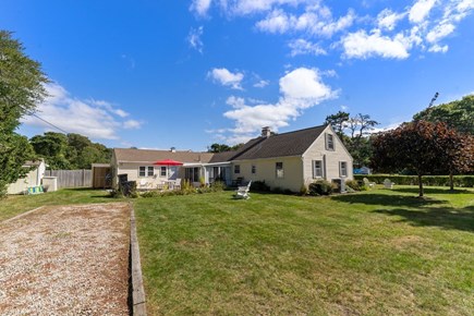 West Yarmouth Cape Cod vacation rental - Yard, 2 driveways, patio w/ fire pit, outdoor dining set, grill