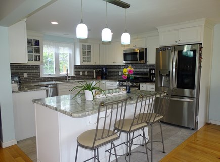 Sandwich - Town Neck Area Cape Cod vacation rental - Kitchen area with updated appliances, breakfast bar