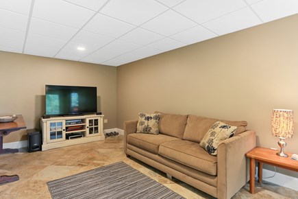 Chatham Cape Cod vacation rental - Spacious lower level media room with sleep sofa, walkout to patio