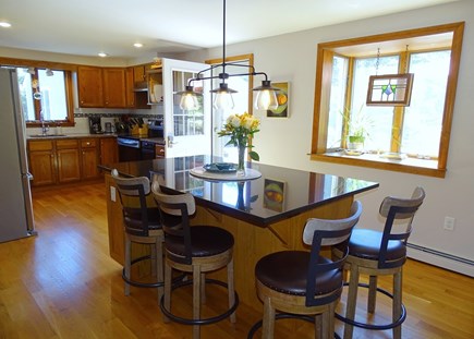Eastham Cape Cod vacation rental - Kitchen with large island seating, door to deck 