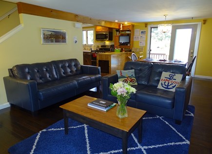 West Yarmouth Cape Cod vacation rental - Living room with fireplace, desk – opens to dining area
