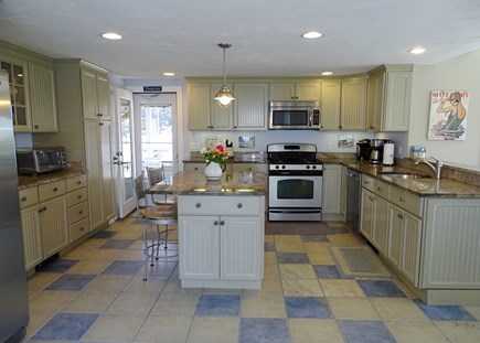 West Dennis Cape Cod vacation rental - Spacious kitchen with center island, slider to front deck 