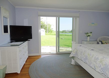 West Dennis Cape Cod vacation rental - King bedroom with TV, slider to back deck w/ water views 
