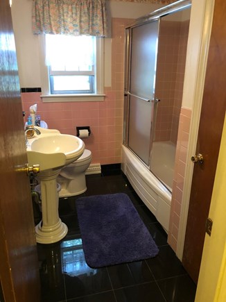 West Hyannisport Cape Cod vacation rental - 1st floor bath, granite floor, pedestal sink & nice shower/tub.