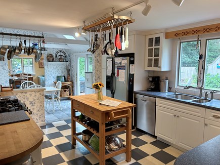 Brewster, The Highlands Cape Cod vacation rental - Kitchen opens to sunroom, slider to back yard