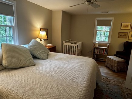 Brewster Cape Cod vacation rental - Primary Bedroom with King bed, reading chair and crib