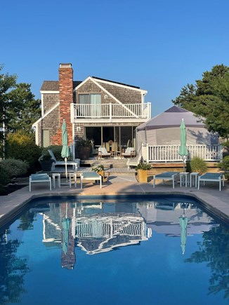 North Eastham Cape Cod vacation rental - Pool area looking back at house with screened in Canopy