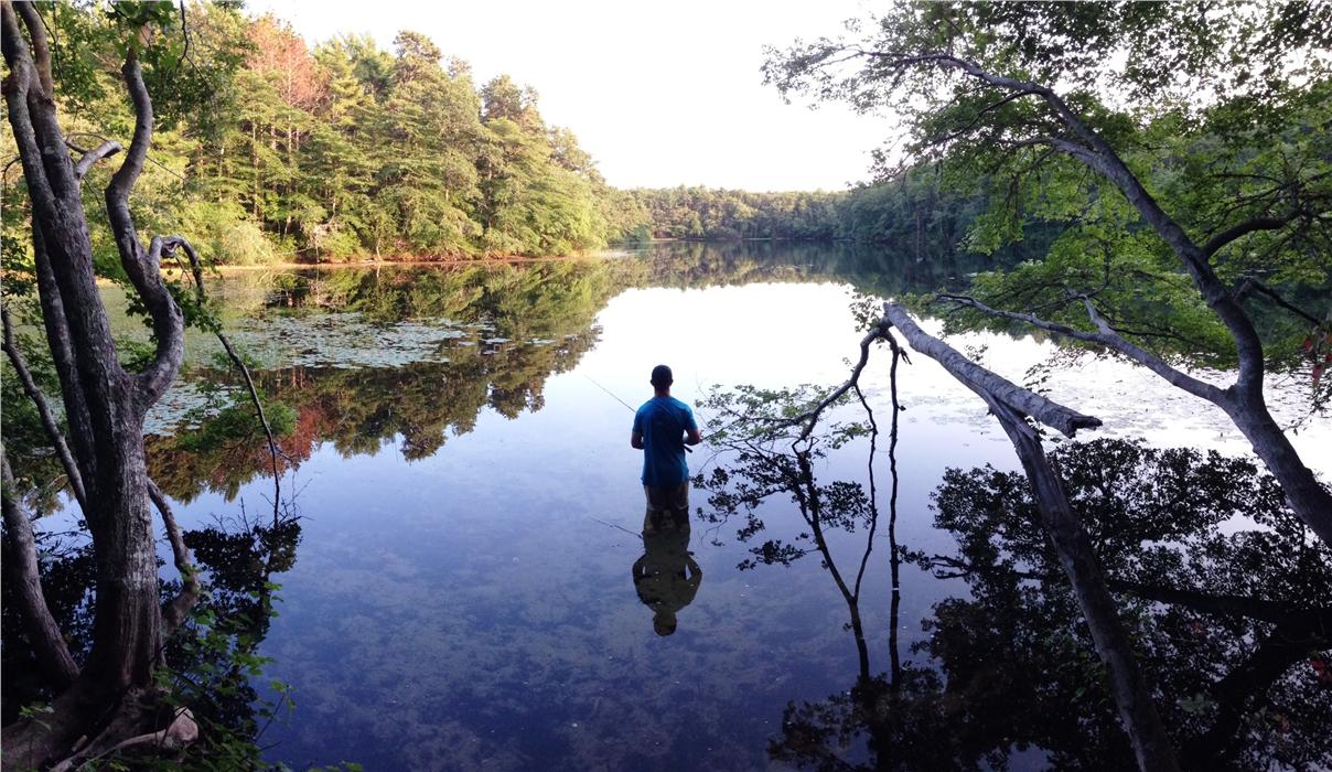 Late afternoon at Eagle Pond, Joe is casting for small bass, and not caring whether he catches one.