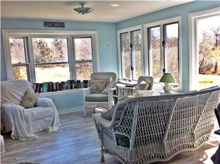Oak Bluffs, Waban Park Martha's Vineyard vacation rental - The sunroom, with water views, wicker chairs and lots of books.