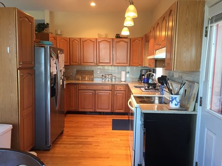 Oak Bluffs - East Chop Martha's Vineyard vacation rental - Kitchen w deck access and ocean views through dining area