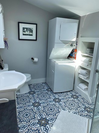 Edgartown Martha's Vineyard vacation rental - Stacking washer/dryer in bathroom with pocket door to LR.